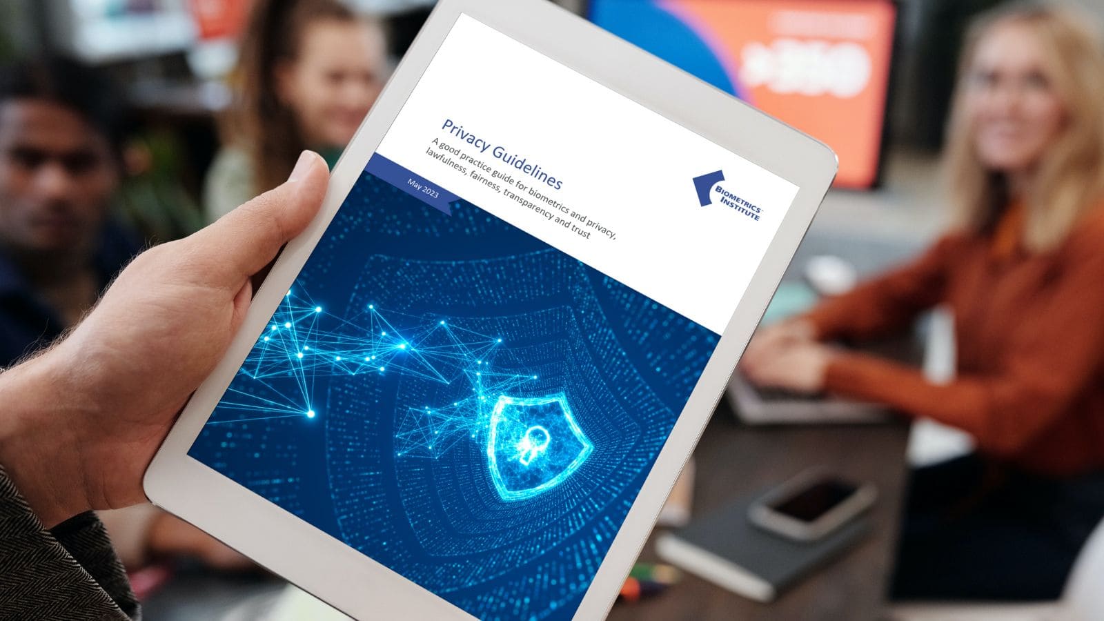 Colleagues viewing the Biometrics Instituteās Privacy Guidelines on an iPad