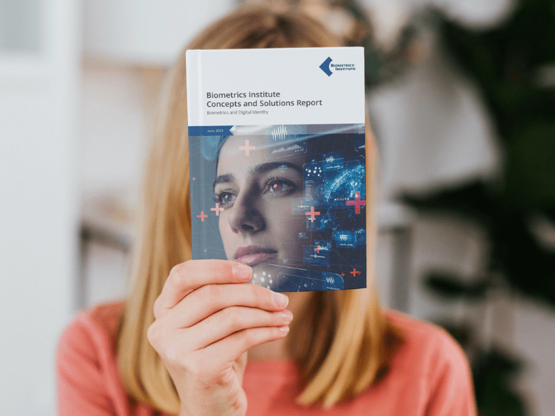 Woman holding Biometrics Institute Digital Identity document