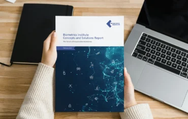 Woman holding a Biometrics Concepts and Solutions report featuring case studies from Biometrics Institute members on the future of responsible biometrics